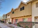 Exterior view of townhouses with brick accents, tidy landscaping, and seating at 8522 E Montebello Ave, Scottsdale, AZ 85250