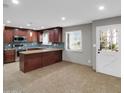 Stylish kitchen with stainless appliances, granite counters, and ample cabinetry at 8522 E Montebello Ave, Scottsdale, AZ 85250