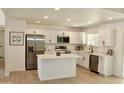 Bright kitchen features white cabinetry, stainless steel appliances, and a functional center island at 9019 W Griswold Rd, Peoria, AZ 85345