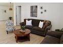 Cozy living room with stylish furnishings and wood-look flooring offers a welcoming space at 9019 W Griswold Rd, Peoria, AZ 85345
