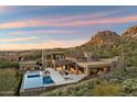 Stunning estate featuring a pool, multiple patios, and mountain views at sunset at 10585 E Crescent Moon Dr # 44, Scottsdale, AZ 85262