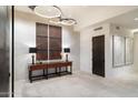 Bright foyer featuring tile flooring, unique lighting fixtures and artwork on the wall at 10585 E Crescent Moon Dr # 44, Scottsdale, AZ 85262