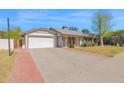 Single-story home featuring a well-maintained yard, covered entryway, and two-car garage at 1166 E Del Rio St, Chandler, AZ 85225