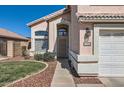 The front entrance with desert landscaping and a two car garage at 13444 W Ocotillo Ln, Surprise, AZ 85374