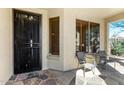 Inviting front porch with outdoor seating area and secure entry door at 1412 E Jade Dr, Chandler, AZ 85286