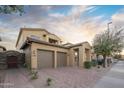 Inviting home with a two-car garage, covered entryway, and low-maintenance desert landscaping at 14257 W Harvard St, Goodyear, AZ 85395