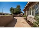 Inviting front patio with stone pavers and outdoor seating, perfect for enjoying the landscaped garden area at 1506 E Gemini Dr, Tempe, AZ 85283