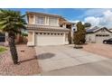 Two-story home featuring a neutral color scheme, two-car garage, tile roof, and desert landscaping at 15618 N 12Th Ave, Phoenix, AZ 85023