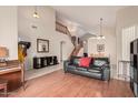 Open floor plan featuring wood floors, a staircase, and a neutral color scheme at 15618 N 12Th Ave, Phoenix, AZ 85023