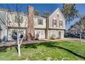 Inviting townhome exterior with a classic brick chimney and green lawn at 1600 N Saba St # 224, Chandler, AZ 85225