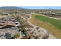 Stunning aerial view of a home showcasing a backyard pool, golf course views, and solar panels at 18059 W Ocotillo Ave, Goodyear, AZ 85338