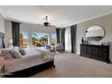 Serene main bedroom featuring neutral tones, backyard views, and ample natural light at 18059 W Ocotillo Ave, Goodyear, AZ 85338