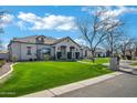 Lovely single-story home featuring a lush lawn, beautiful landscaping, and excellent curb appeal at 20125 E Melissa Pl, Queen Creek, AZ 85142