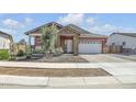 Charming single-story home featuring stone accents, a two-car garage, and desert landscaping at 21757 S 191St Pl, Queen Creek, AZ 85142