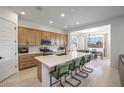 Bright kitchen featuring a large island with seating, modern appliances, and an adjacent dining area at 21757 S 191St Pl, Queen Creek, AZ 85142