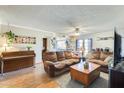 Cozy living room with hardwood floors, comfortable seating, and seamless flow into the dining area at 2202 N Los Altos Dr, Chandler, AZ 85224