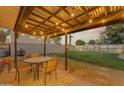 Cozy covered patio with string lights, outdoor dining set, and view of a well-maintained backyard at 2209 N 23Rd St, Phoenix, AZ 85006