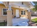 Inviting front porch featuring stylish columns and a 'hello' welcome mat at 2209 N 8Th St, Phoenix, AZ 85006