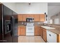 Functional kitchen with essential appliances, tile flooring, and ample cabinet space for storage at 2251 E Remington Pl, Chandler, AZ 85286