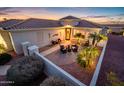 Inviting courtyard with comfortable seating surrounded by lush landscaping and tasteful outdoor lighting at 23318 N Las Positas Ct, Sun City West, AZ 85375