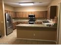 Spacious kitchen with stainless steel appliances, granite countertops, and ample cabinet space at 25646 W Elwood St, Buckeye, AZ 85326