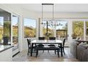 Open dining area with large windows, a modern chandelier, and a table perfect for Gathering gatherings at 27641 N 74Th St, Scottsdale, AZ 85266