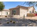 Beige home featuring desert landscaping with rocks, cacti, and colorful flowering bushes at 27913 N Walnut Creek Rd, Rio Verde, AZ 85263