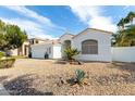 Striking single-story home featuring low-maintenance desert landscaping and a classic tiled roof at 2909 N 111Th Dr, Avondale, AZ 85392