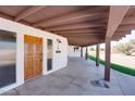 Inviting front entry with beautifully crafted wood door and modern lighting fixture at 350 N 9Th St, Coolidge, AZ 85128