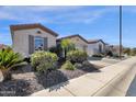 Beautiful single-story home featuring manicured landscaping, neutral colors, and brick-lined driveway at 4483 E Sourwood Dr, Gilbert, AZ 85298