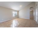 Spacious living room featuring vaulted ceilings and tile flooring at 5125 W Wikieup Ln, Glendale, AZ 85308