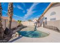 Private backyard pool surrounded by mature landscaping and privacy fence at 5125 W Wikieup Ln, Glendale, AZ 85308