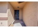 A close-up of the home's front door with adjacent stucco wall at 516 E Mesquite Ave, Apache Junction, AZ 85119