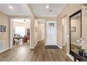 Bright entryway features wood-look floors and neutral paint. There is a large mirror on the right-hand wall at 5165 S Peach Willow Ln, Gilbert, AZ 85298