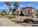 Single-story home with well-maintained desert landscaping and a charming curb appeal at 5165 S Peach Willow Ln, Gilbert, AZ 85298