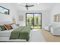 Bright main bedroom featuring a ceiling fan and a large window with backyard view at 6313 N 10Th Dr, Phoenix, AZ 85013