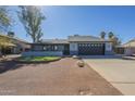 Charming single-story home featuring a low wall with decorative stone and a gravel yard at 6841 W Yucca St, Peoria, AZ 85345