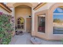 Inviting front porch featuring decorative plants, a bench, and a charming entrance to the home at 7703 E Sayan St, Mesa, AZ 85207