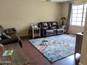 Cozy living room with hardwood floors, comfortable seating, and plenty of natural light at 9196 E Evans Dr, Scottsdale, AZ 85260