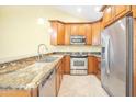 Well-equipped kitchen featuring granite countertops and stainless steel appliances at 9463 E Jenan Dr, Scottsdale, AZ 85260