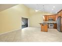 Open-concept living space with tile flooring, adjacent to kitchen with stainless appliances at 9463 E Jenan Dr, Scottsdale, AZ 85260