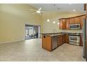 Bright, open kitchen and living area featuring modern appliances and sliding glass doors to patio at 9463 E Jenan Dr, Scottsdale, AZ 85260