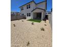 Low-maintenance backyard with gravel, artificial turf, a covered patio, and block wall fencing at 9831 S 11Th St, Phoenix, AZ 85042