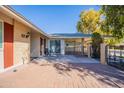 This home offers a spacious backyard with a covered carport and brick-paved patio at 14006 N Tumblebrook Way, Sun City, AZ 85351