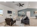 Bright living room featuring wood-look floors, blue accent wall, modern decor, and ample natural light at 16560 N Slate Ln, Maricopa, AZ 85139