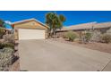 Single-story home featuring a two-car garage and desert landscaping at 2106 E 39Th Ave, Apache Junction, AZ 85119