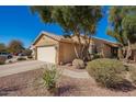 Single-story home featuring a two-car garage and desert landscaping at 2106 E 39Th Ave, Apache Junction, AZ 85119