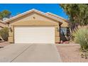 Front view of attached two car garage with tan paint at 2106 E 39Th Ave, Apache Junction, AZ 85119