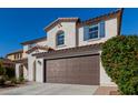 Beautiful home with a brown garage door at 21978 N 97Th Dr, Peoria, AZ 85383