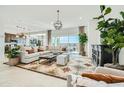 Bright living room features a modern light fixture, an open floorplan, and a large sofa at 23193 E Nightingale Rd, Queen Creek, AZ 85142